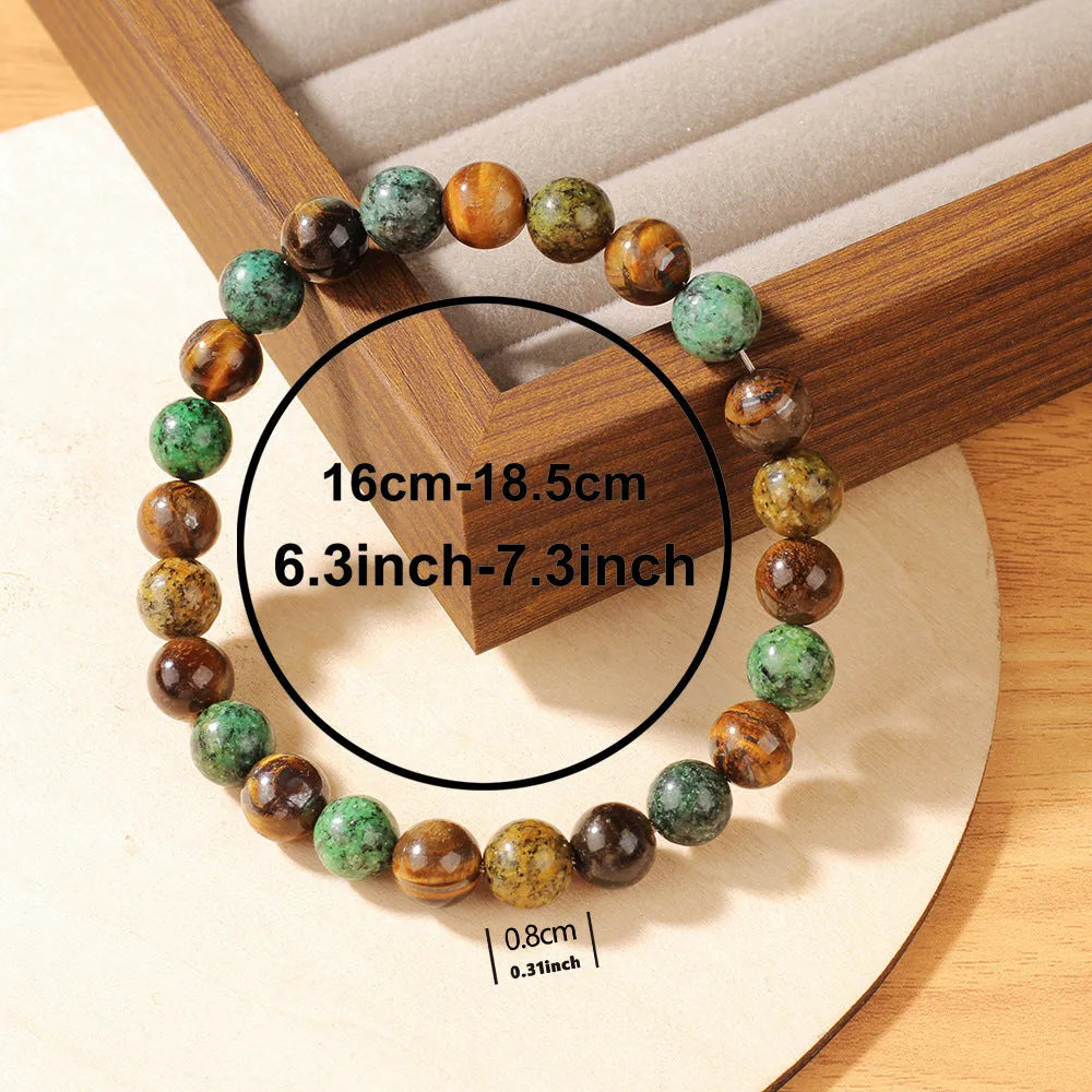 Handmade Tigereye stone bracelet with large flower-shaped bead and adjustable metal clasp on a cord.