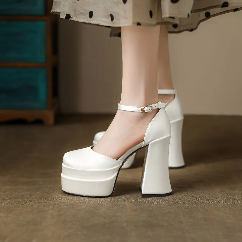Women's white chunky heel platform pumps with a round toe and waterproof upper on a rubber sole.