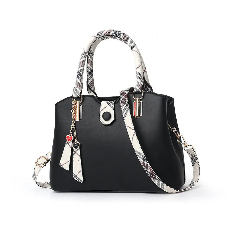 Ladies handbag in PU leather, medium Boston bag shape, square vertical section, with zipper closure and metal accents
