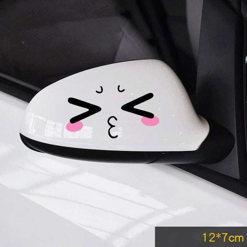Pair of reflective cartoon car stickers with cute eye designs on a white background.