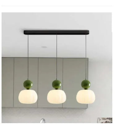Creative pumpkin-shaped Nordic style ceiling chandelier in alloy, shown in single head and three head configurations.