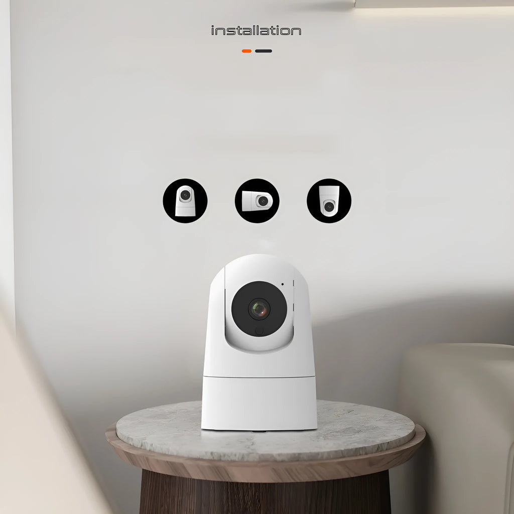 White indoor security camera with shake head function on a desk, showing UK plug.