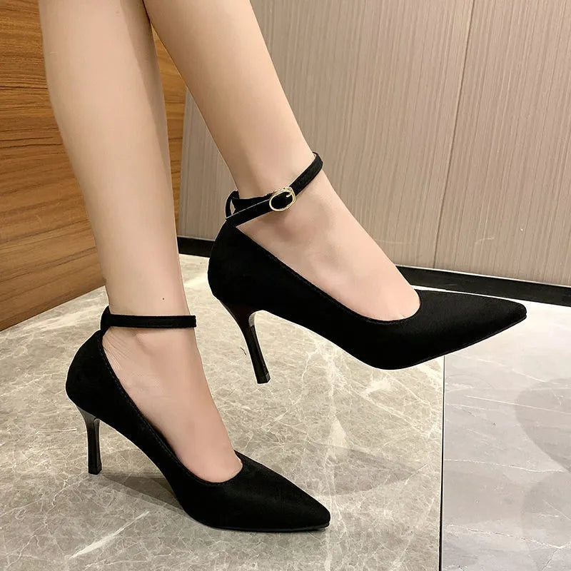 Black and white women's stiletto high heel shoes with skull pattern and ankle buckle.