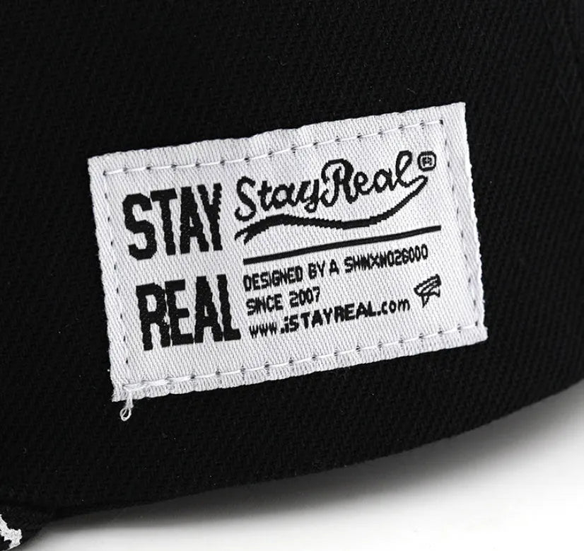 Cotton baseball cap with embroidered lettering on the front, shown in black and white colours