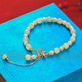 Women's Hetian jade bracelet with round pearl pendant and gold electroplated metal links