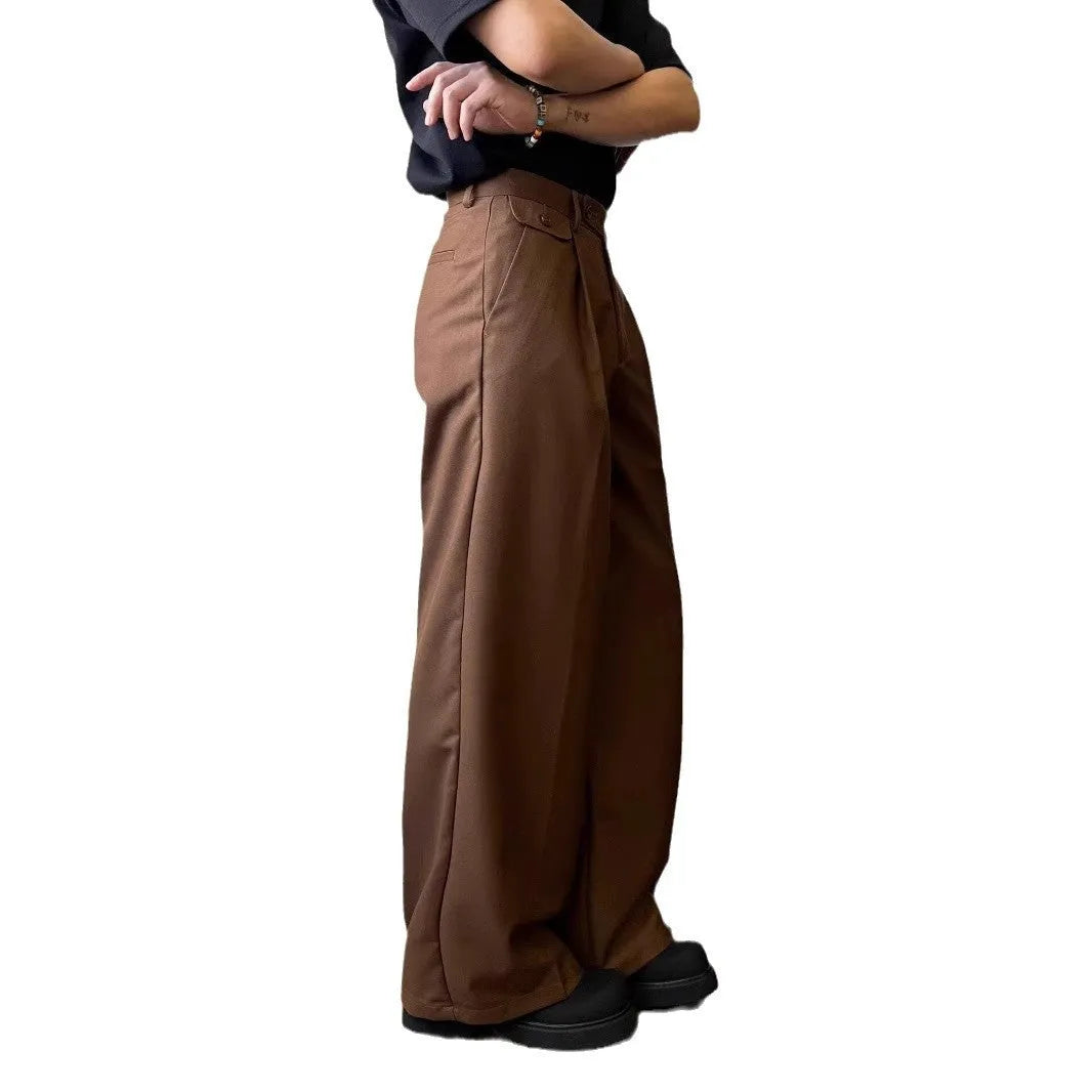 Man wearing solid colour straight-leg casual suit trousers with a loose wide-leg draping fit.
