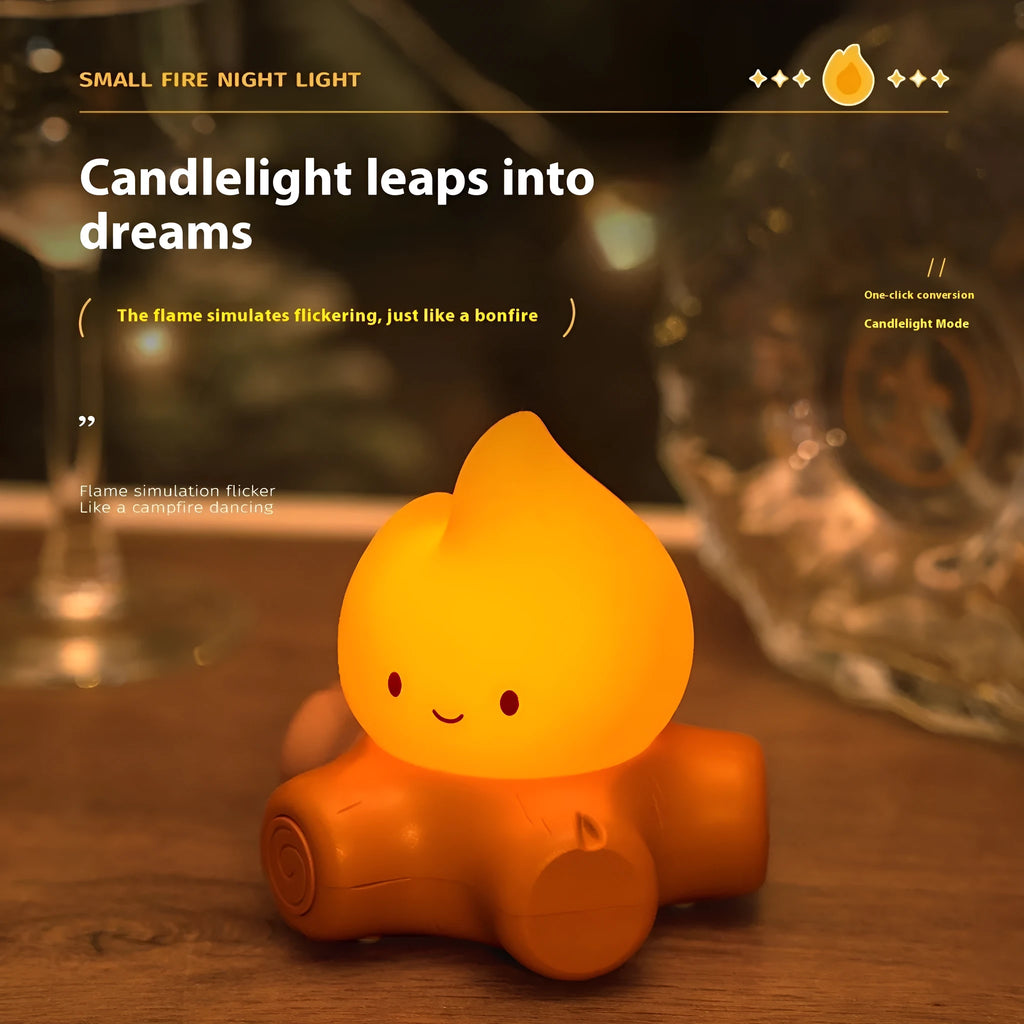 Small cartoon silicone fire pile night lamp with warm yellow lighting on wooden surface
