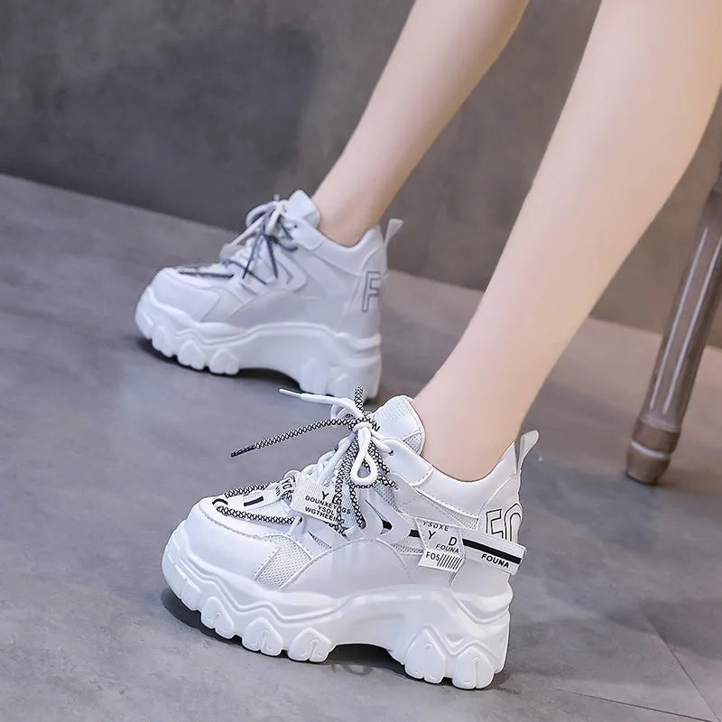 Women's white mesh platform sports shoes with a cross strap and rubber sole.