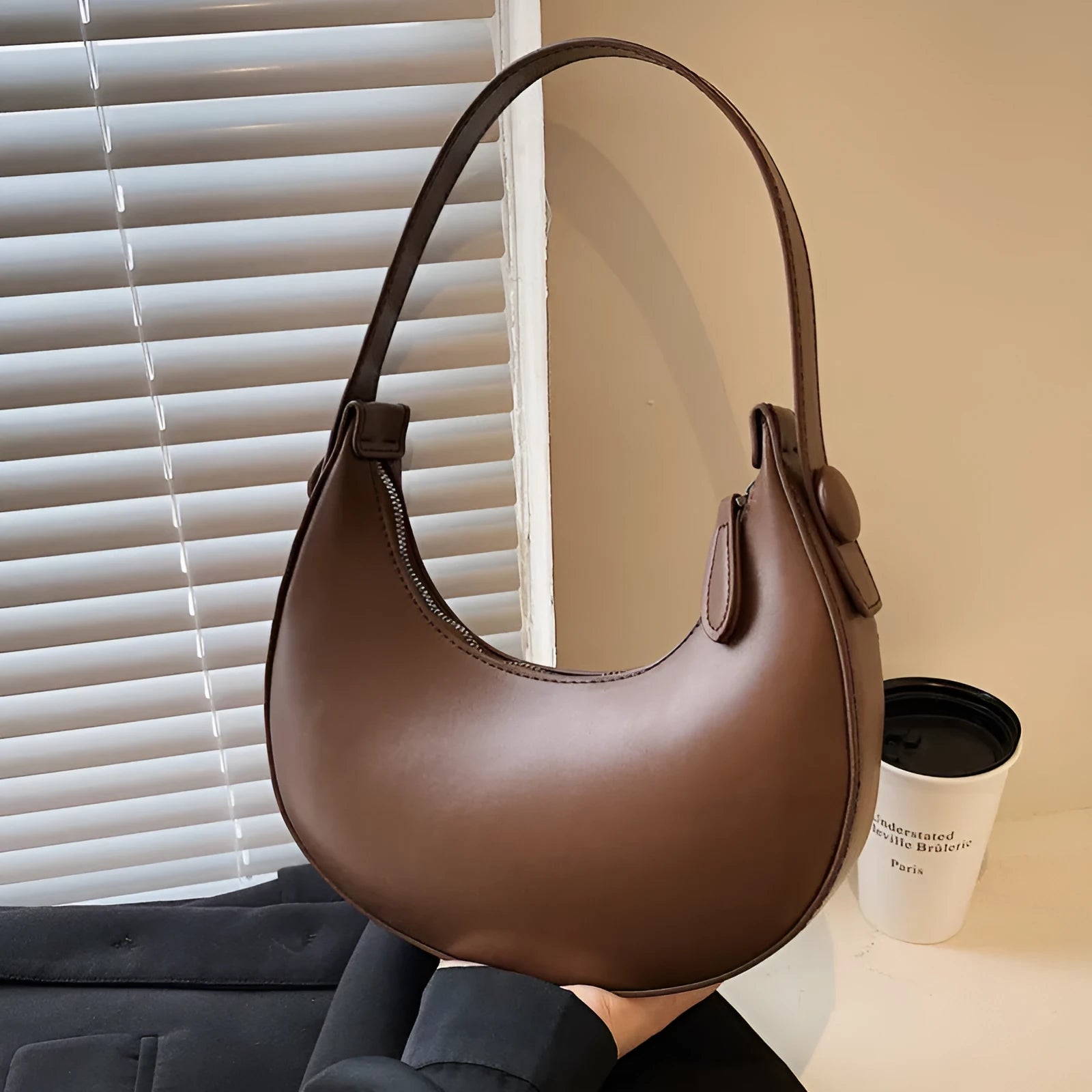 Women's retro dumpling-shaped shoulder bag in PU, shown in one of four colours, featuring an outer pocket and internal zipper compartment.