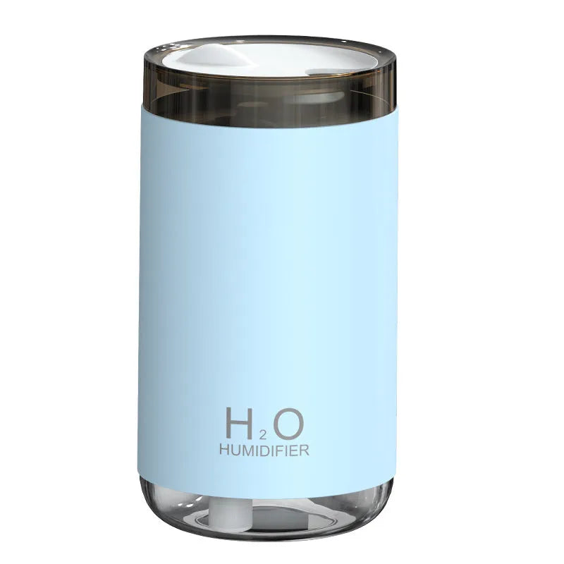 USB jellyfish humidifier producing smoke-ring mist with warm night light in blue, pink, or white colours