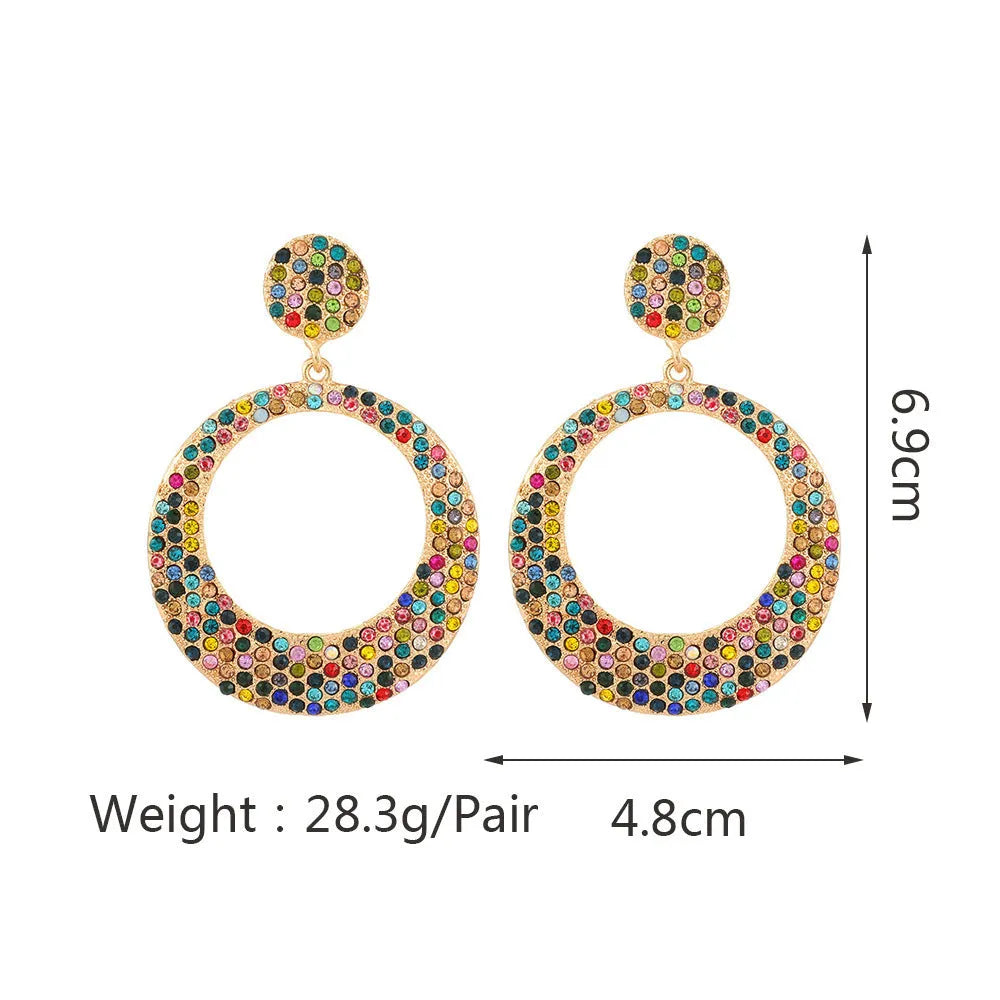 Large round pendant earrings with colourful diamond details on alloy metal, cartoon style