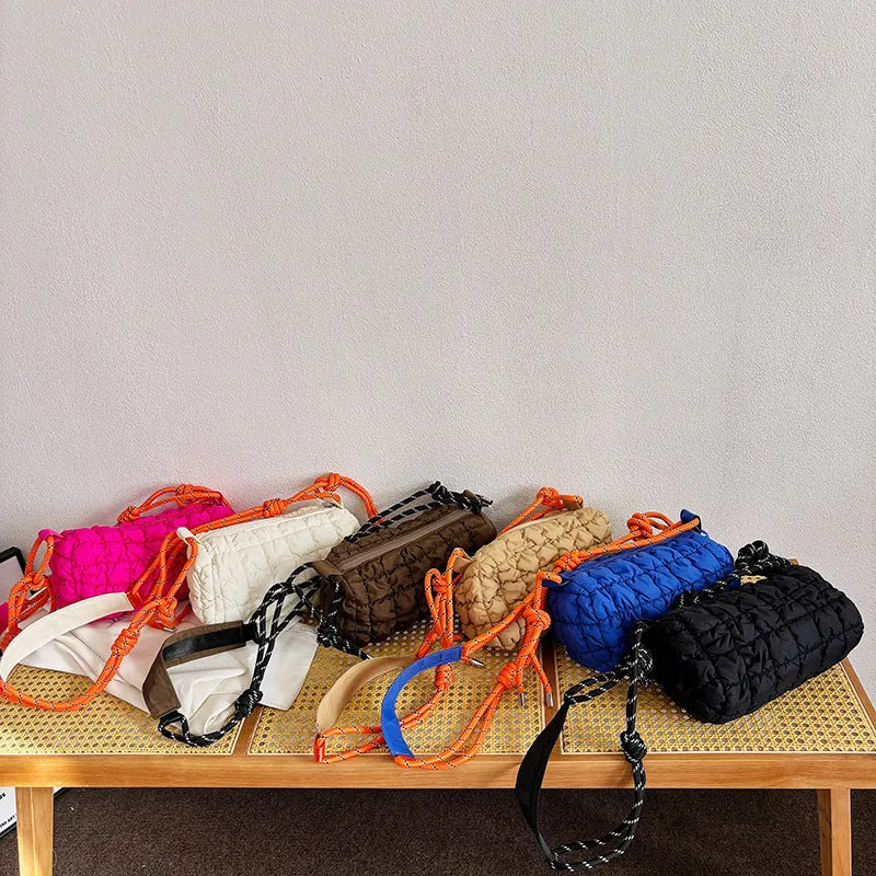 Women's lightweight nylon messenger bag in pillow shape with a crossbody strap, shown in rose red with a rhombus pattern.