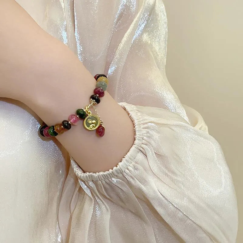 Colourful natural tourmaline abacus bead bracelet with a rabbit pendant charm.