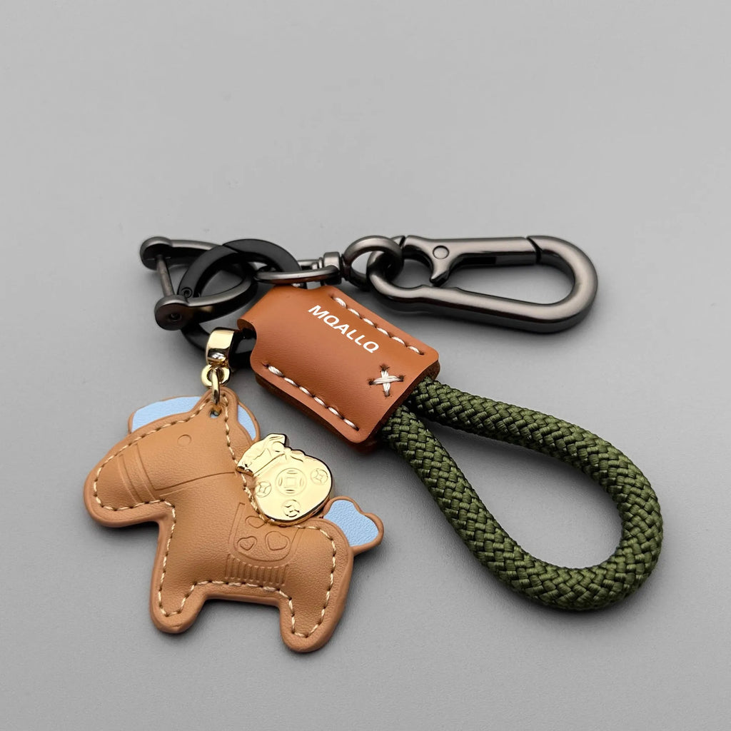 Handmade cowhide car key ring pendant with zinc alloy pony belt buckle charm and flanelle rope in various colours.