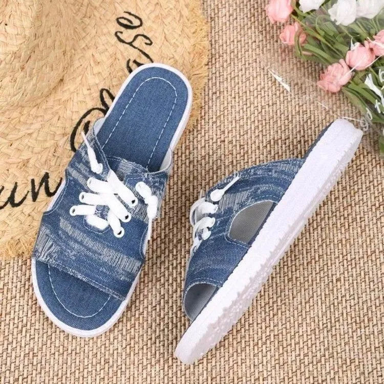 Blue Roman style women's flat canvas slippers with a rubber sole on a plain background.