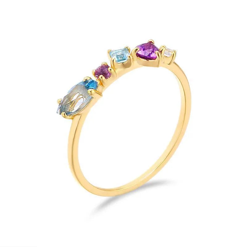 Gold-plated geometric ring with inlaid topaz and white amethyst stones on a white background