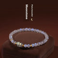 Close-up of a women's moonstone bracelet with zodiac animal design in a traditional Chinese style.