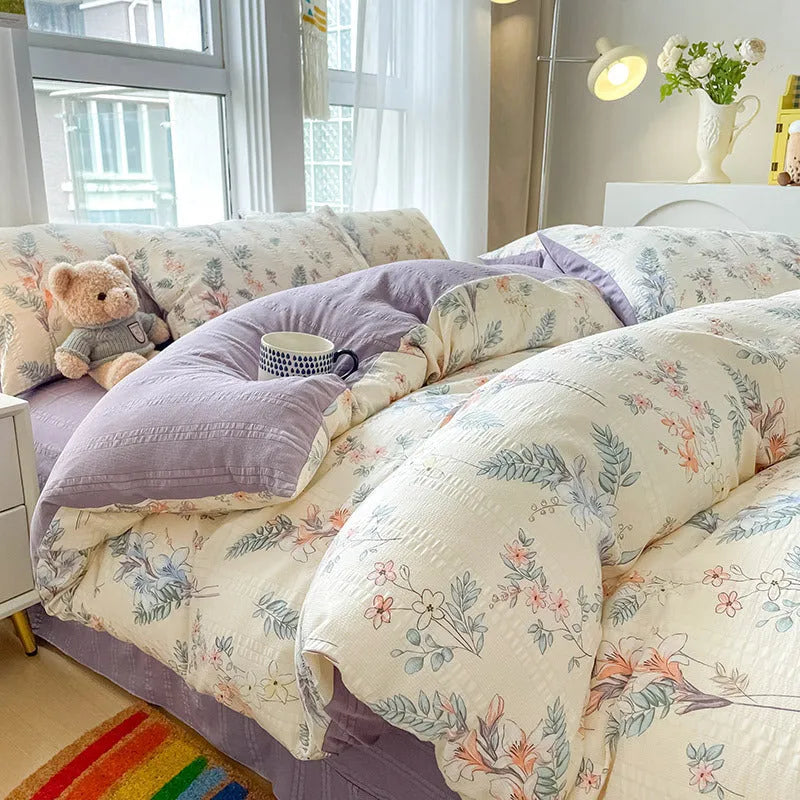 Aerobic jacquard cloud yarn four-piece bedding set with quilt cover, sheet, and pillowcases in a soft pattern.