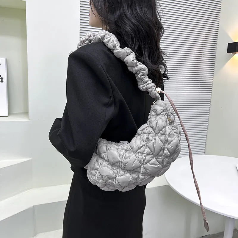 Women's nylon underarm shoulder bag in beige colour showing front view with adjustable strap