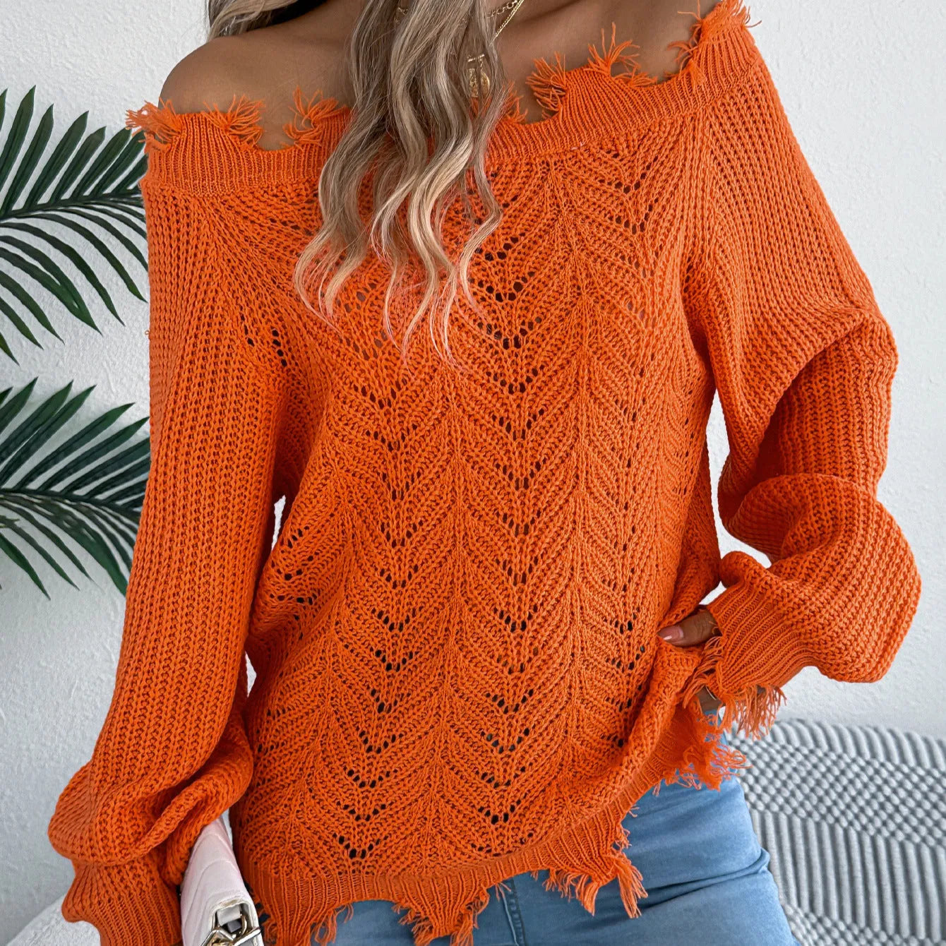 White women's off-the-shoulder pullover sweater with a hollow-out design and long sleeves.