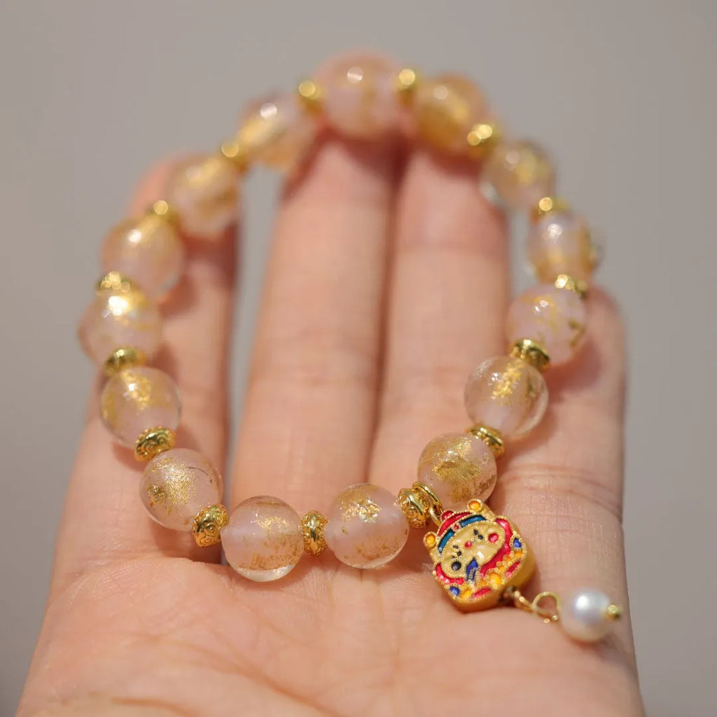 Women's ethnic bracelet with gold foil coloured glaze and geometric design