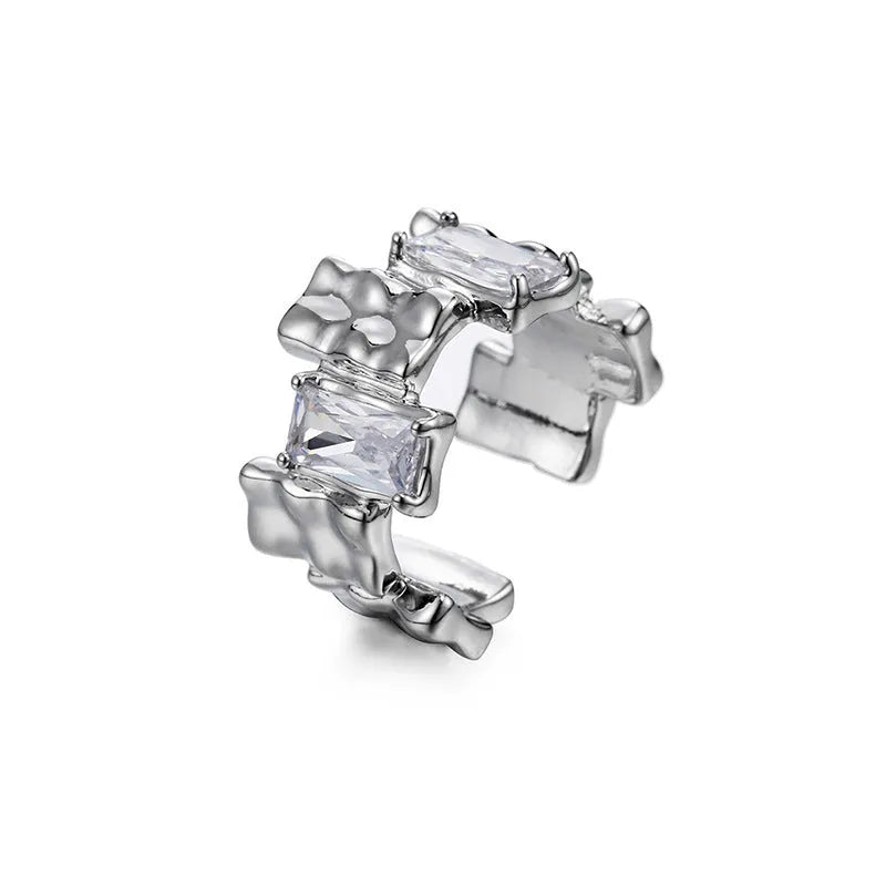 Silver geometric cross ring with open zircon stone setting.
