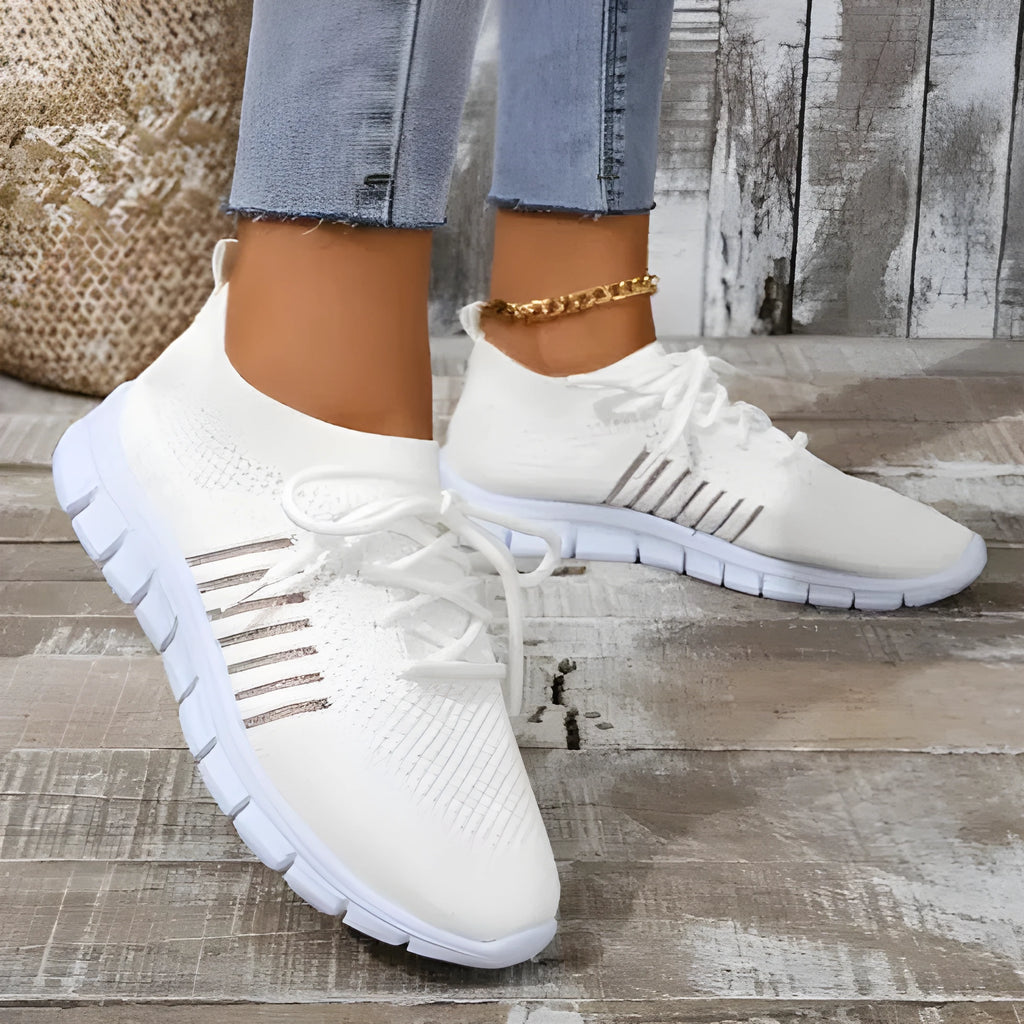 Women's breathable high-cut lace-up casual sneaker on a flat platform heel with a rubber sole.