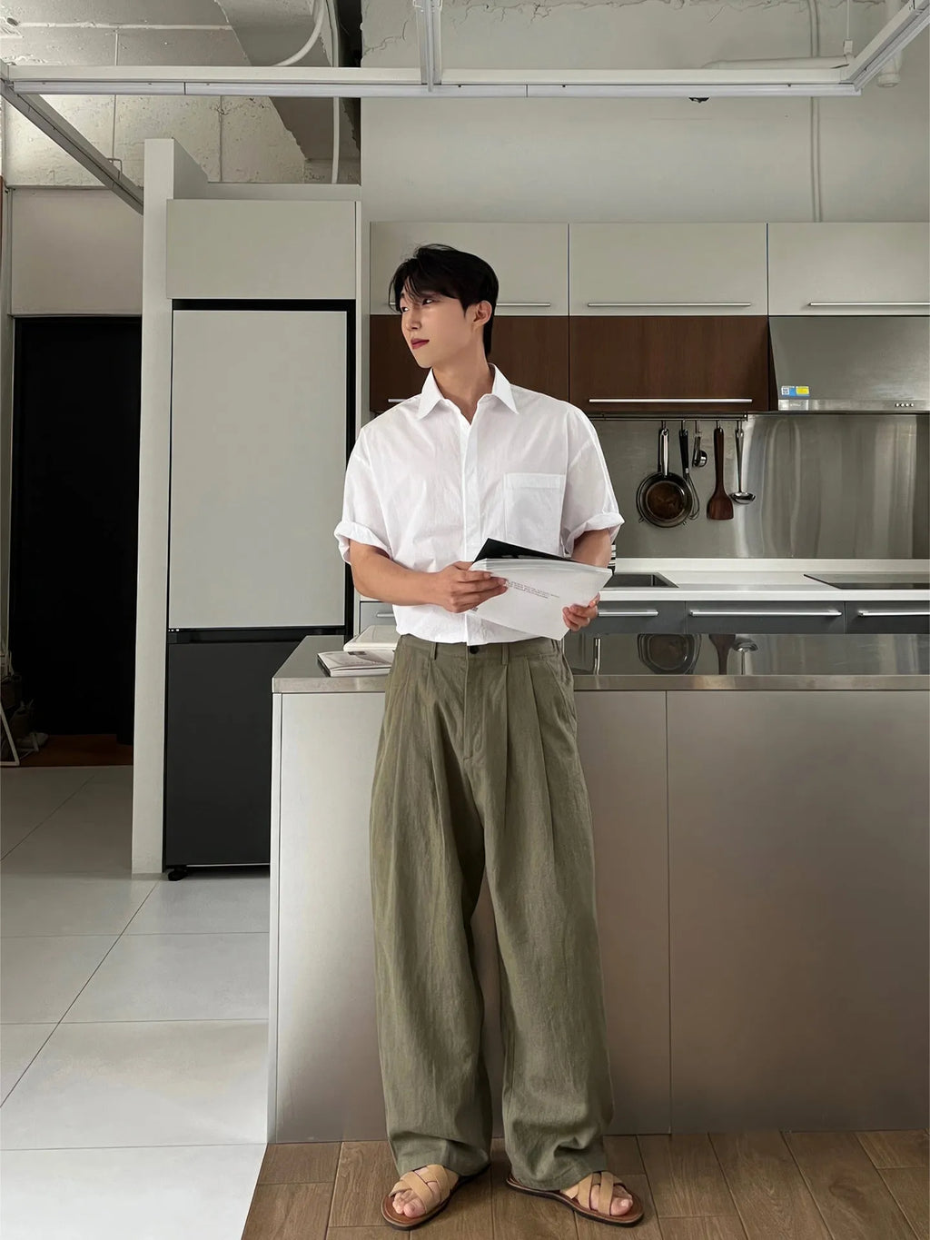 Army green men's casual drawstring waist trousers laid flat, showing the basic style and relaxed fit.