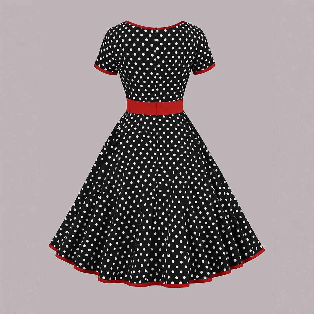 Multicolour polka dot dress with a square collar, short sleeves, front zipper, and pleated mid-length skirt.