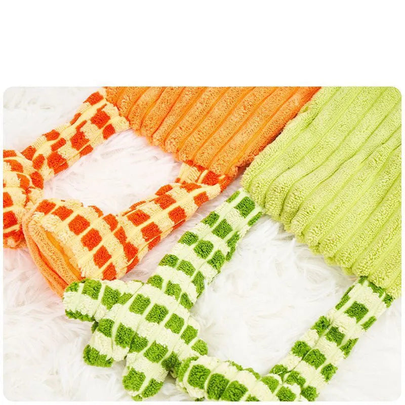 Green and orange plush dog toy with immortal squeaker for aggressive chewers