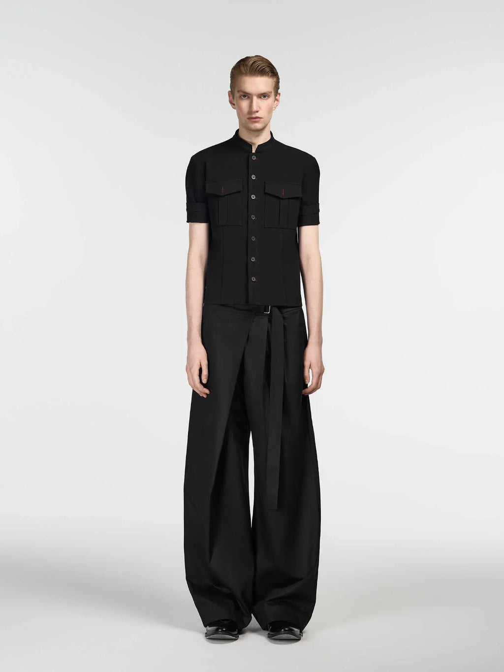 Black women's straight-leg trousers with a single pleat front and adjustable waistband on a hanger.