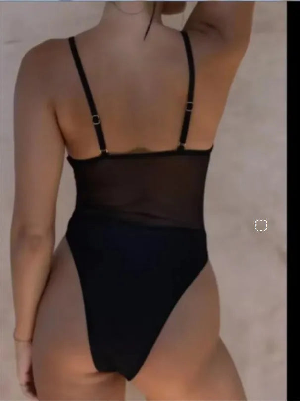 Black women's one-piece swimsuit with transparent mesh panels and banded design.
