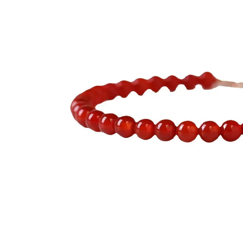A classic style ultra-thin red agate bracelet for women on a white background.