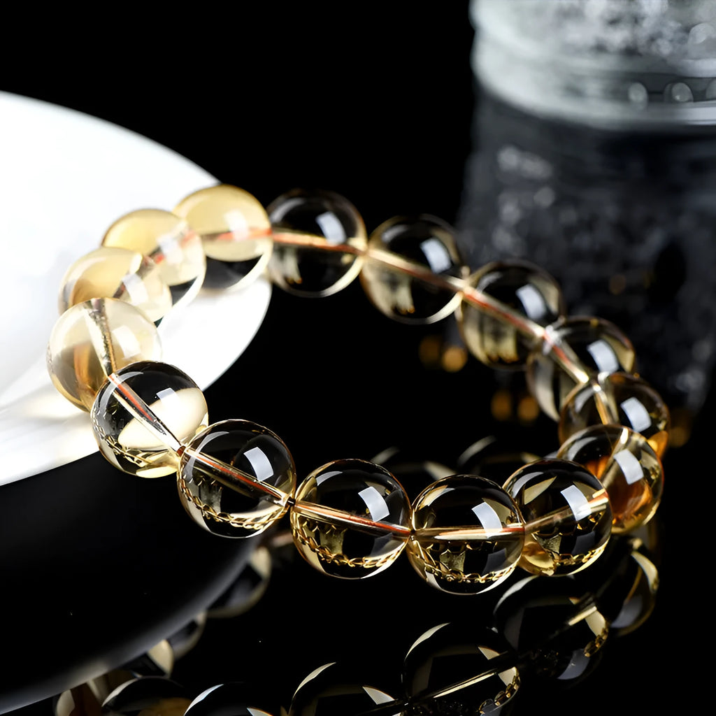 Natural citrine scattered bead bracelet showing spherical gemstone beads in golden colour.