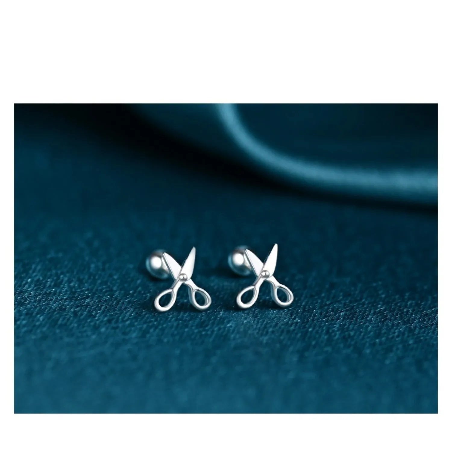 A pair of pure silver screw-style ear nails for cartilage piercings on a plain background.