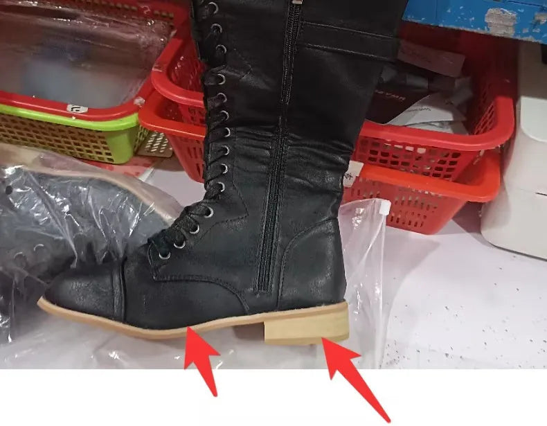 Women's black knight ankle boots with cross strap detailing, made from PU leather.
