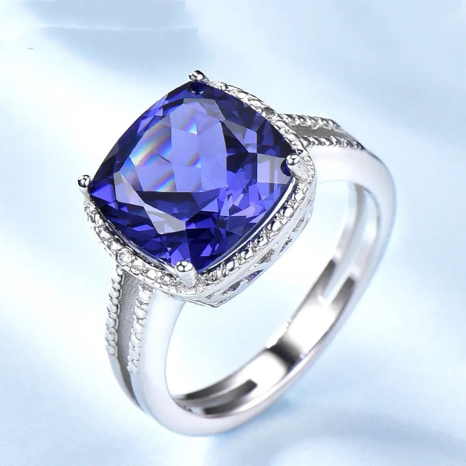 Close-up of a sterling silver ring with a blue tanzanite gemstone.