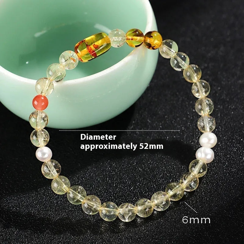 Handmade women's bracelet with white crystal beads, freshwater pearls, and yellow crystal accents