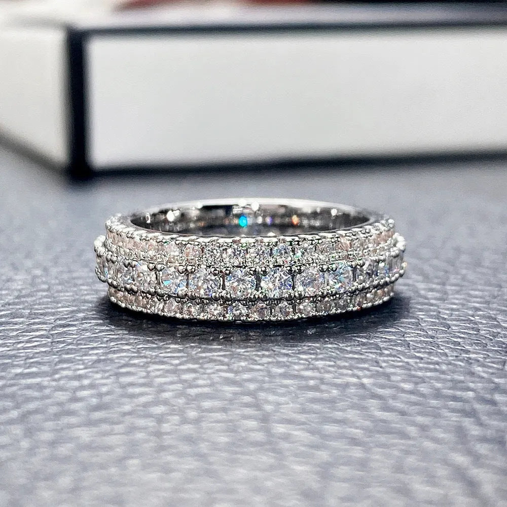Personalised geometric ring with triangle zircon inlay in white gold finish on a hand.