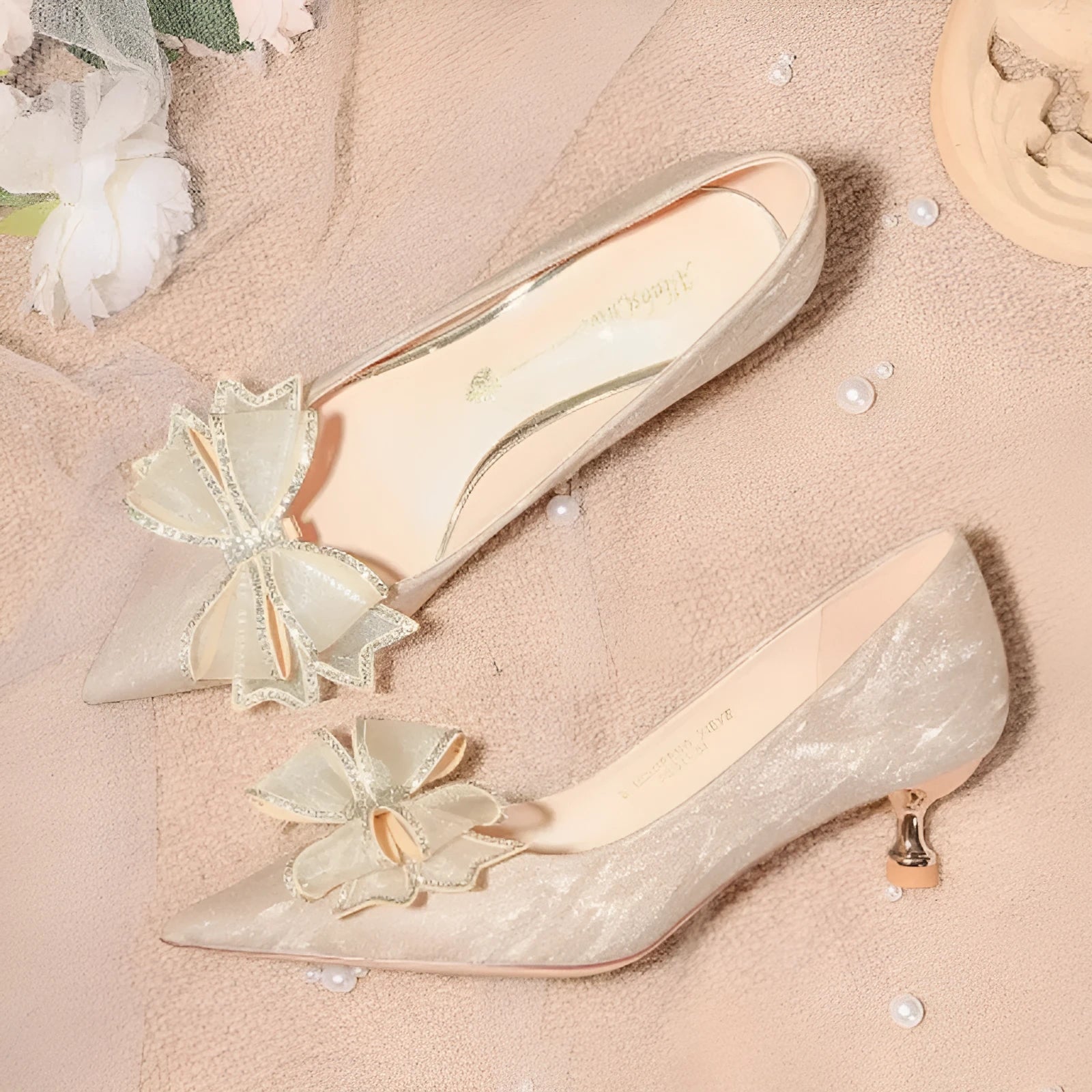 Champagne coloured pointed toe stiletto pumps with sequin detailing and rubber sole
