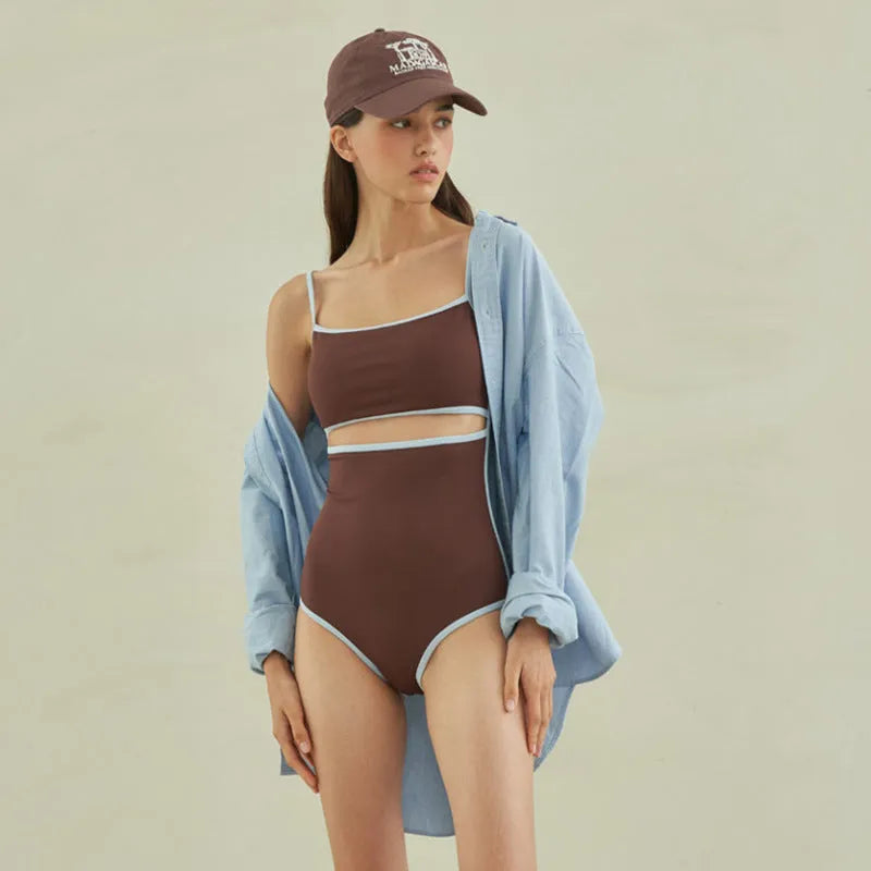 Brown triangle style one-piece swimsuit for women on a hanger