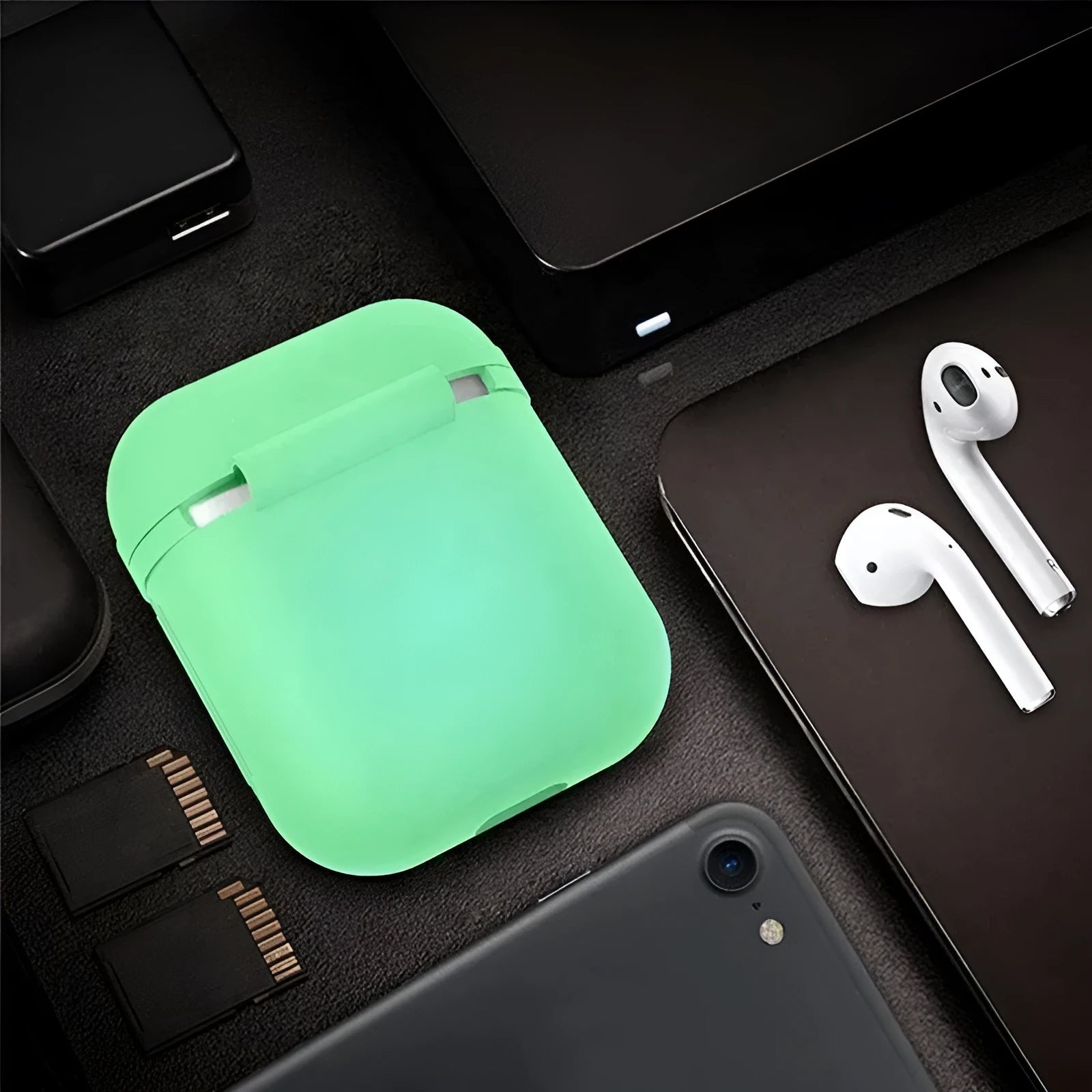 Luminous coloured silicone flip-case for Apple AirPods on a plain background.