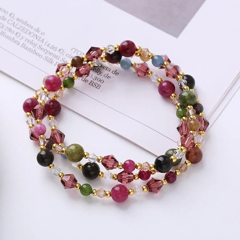 Women's adjustable three-ring bracelet with tourmaline, strawberry quartz and amethyst crystals on cord