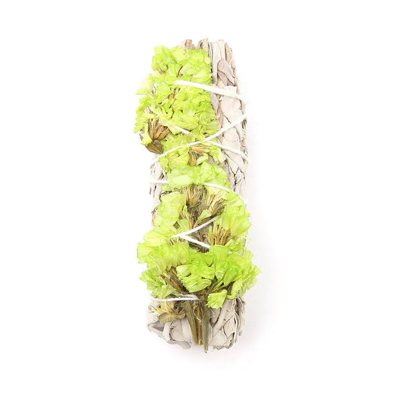 White sage and red rose petal colourful aromatherapy incense bundle on a wooden table