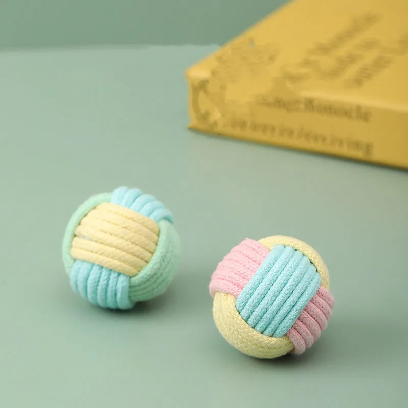 Handmade small blue powder, green blue, and pink green plush cotton ball cat toy for teeth grinding.