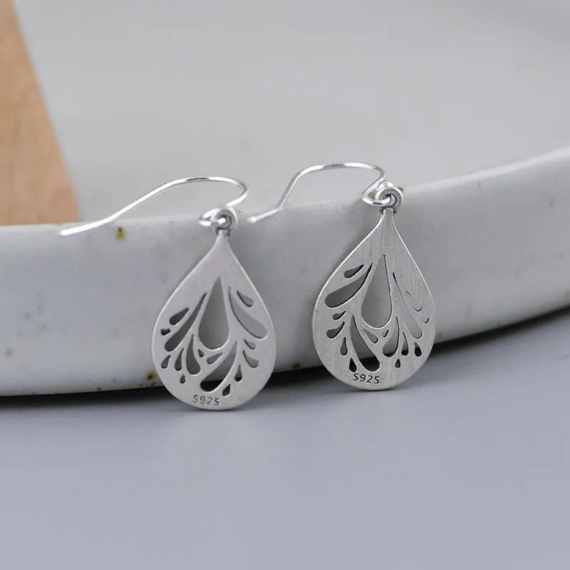 Silver hollow water drop earrings with grinding finish and retro style