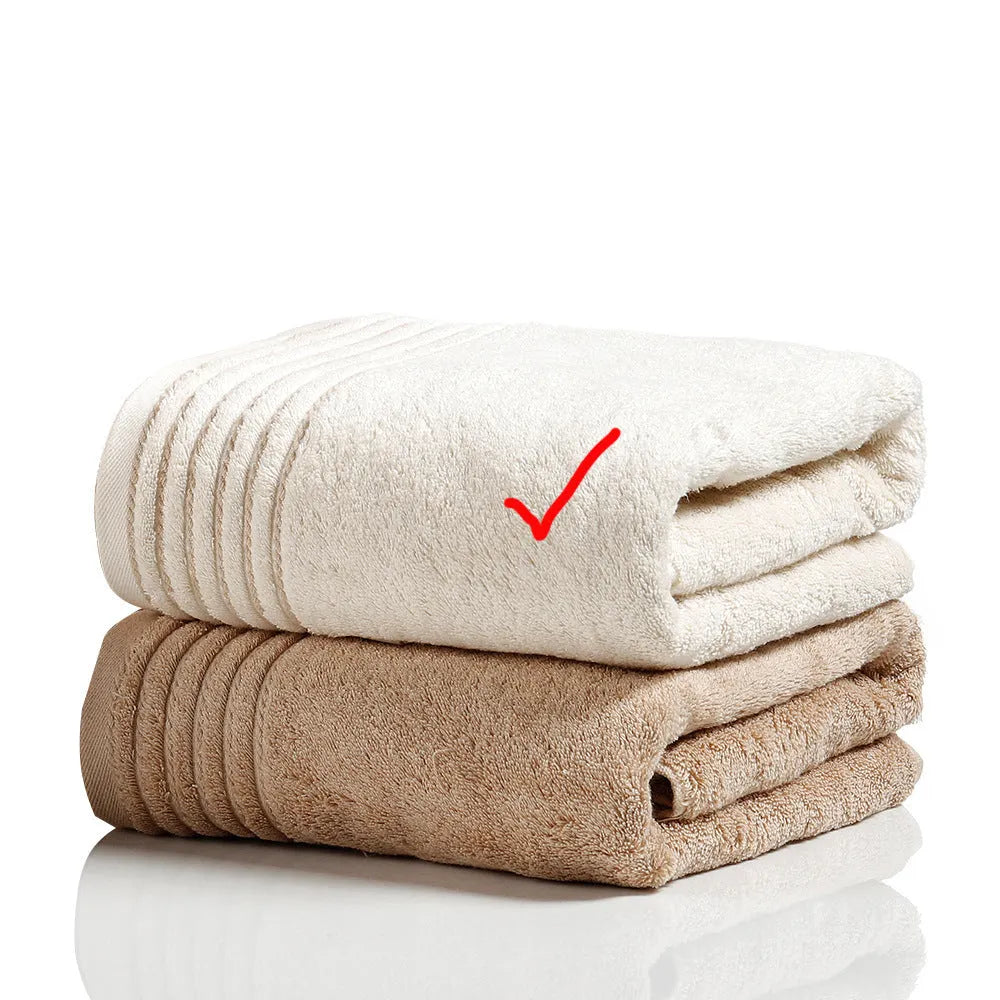Beige and brown cotton towel set showing face cloth, hand towel and bath towel sizes.
