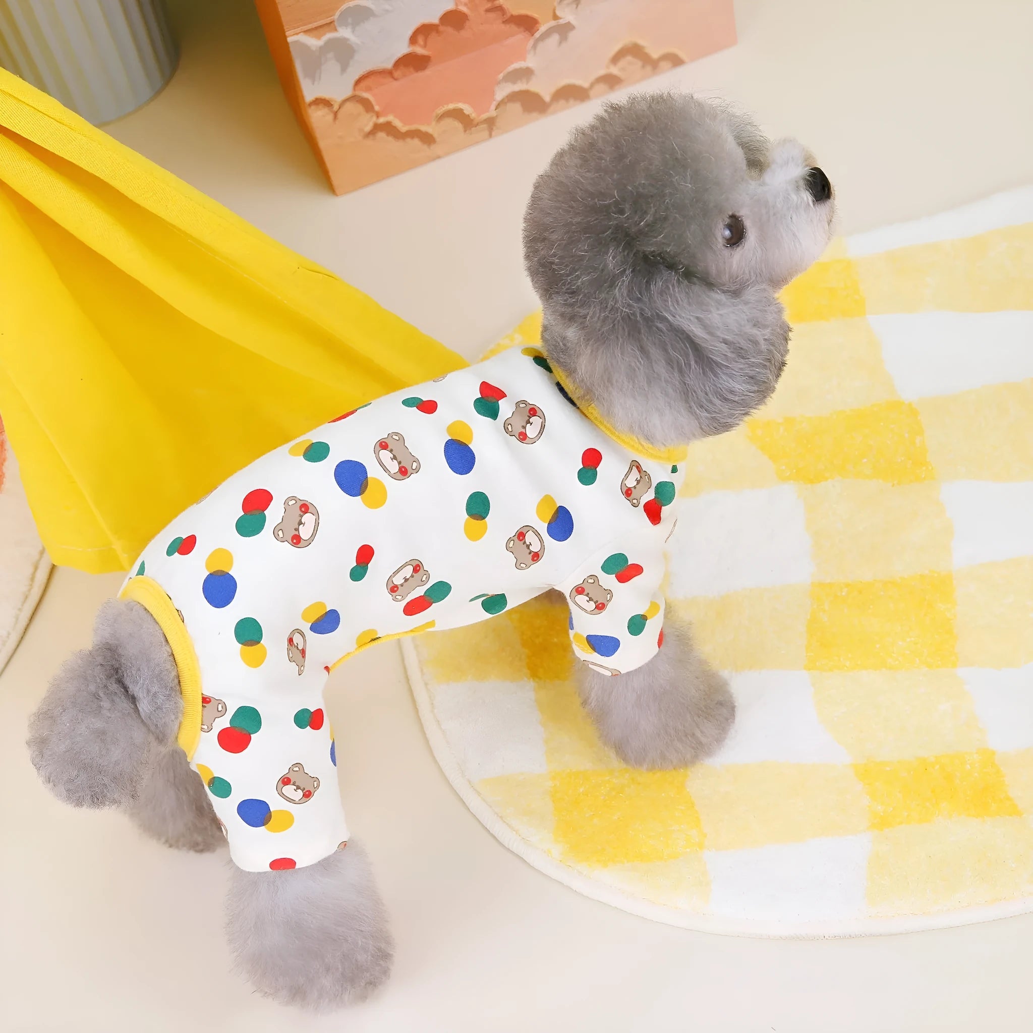 Beige dog jumper with colourful ball bear print, shown on a dog, made from cotton and spandex blend.
