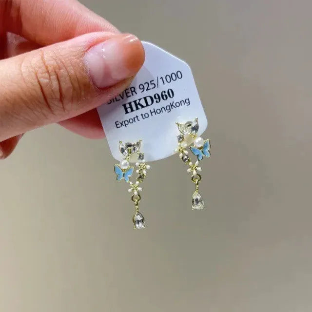 Geometric-shaped women's earrings with heart and star rhinestones and long tassel drops.