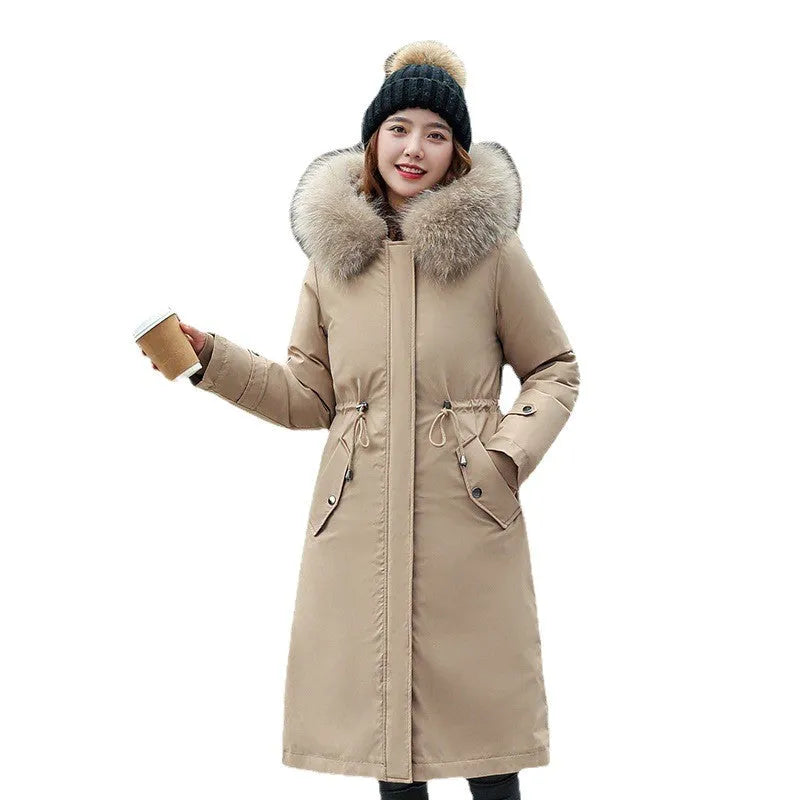 Women's long beige trench coat with cotton-padded construction and belt.